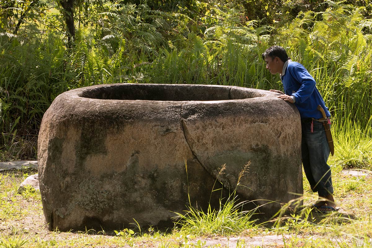 03 Indonesian man inspecting a kalamba near Kolori village, Bada Valley